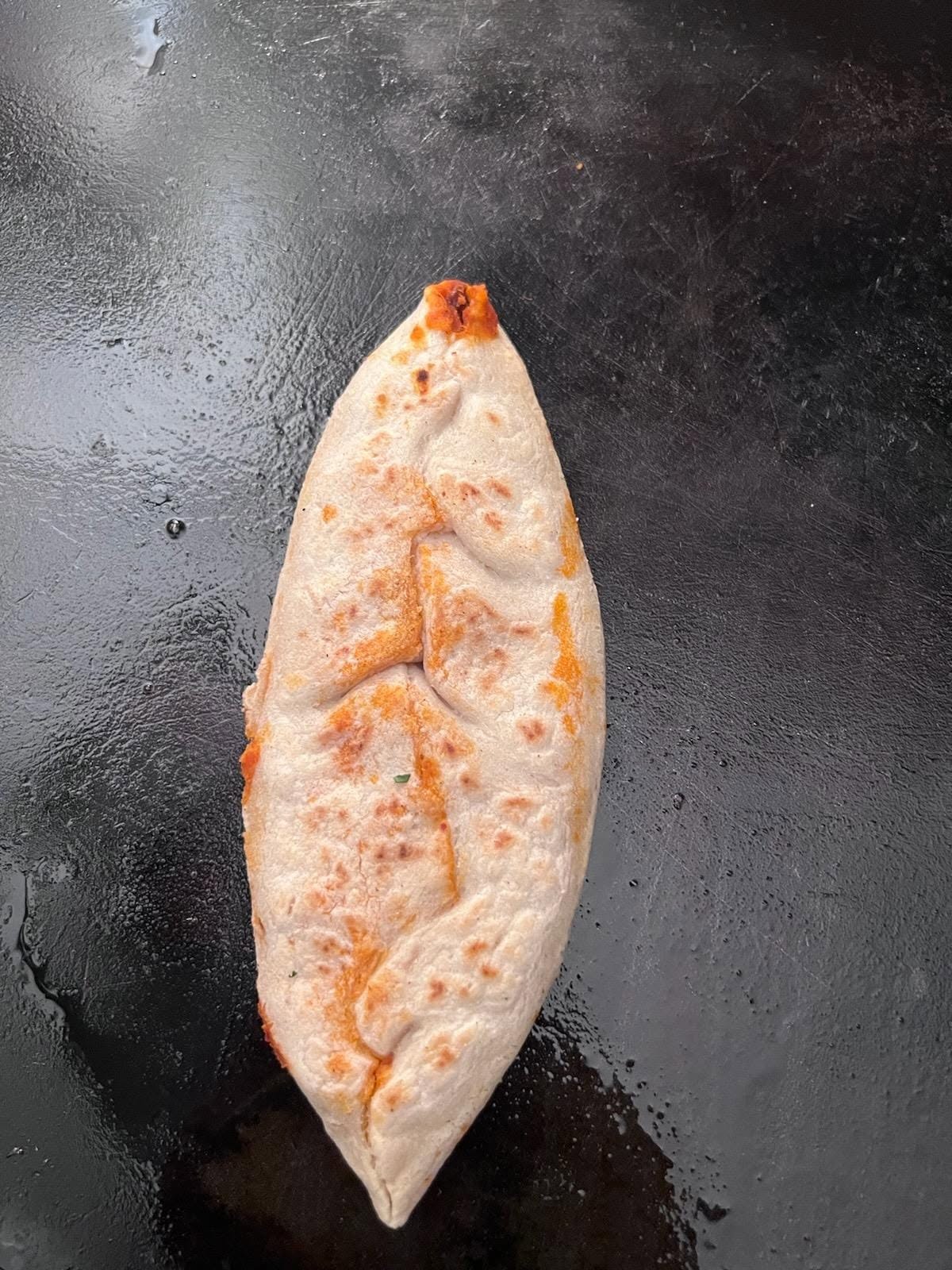 Handmade tlacoyo on the griddle